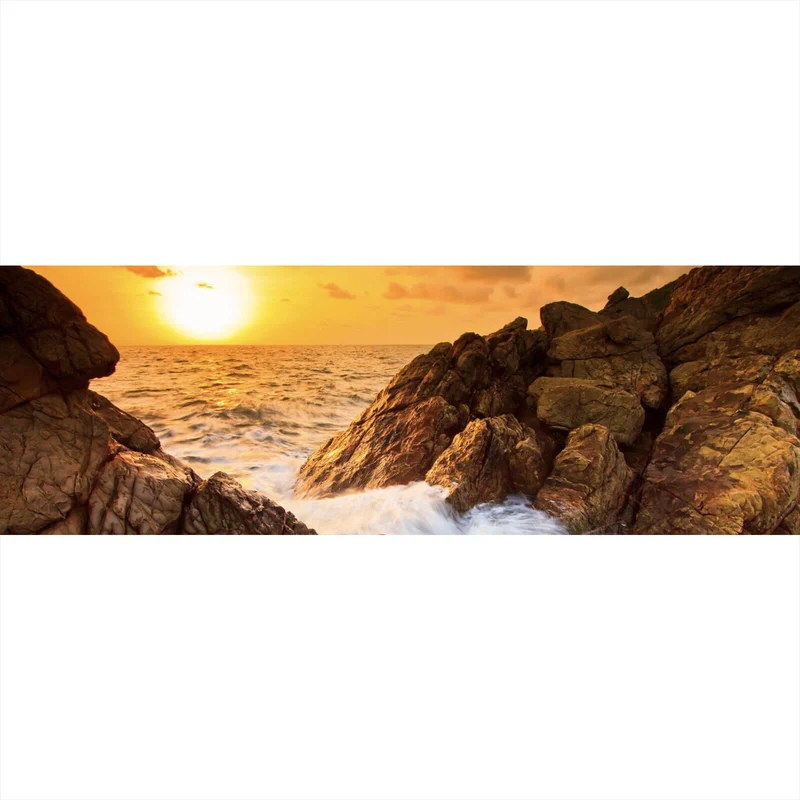 Leinwandbild Sonnenuntergang über felsiger Küstenlandschaft Panorama