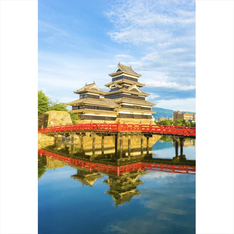 Acrylglasbild Historische Burg mit roter Brücke und Wasserreflektion Hochformat