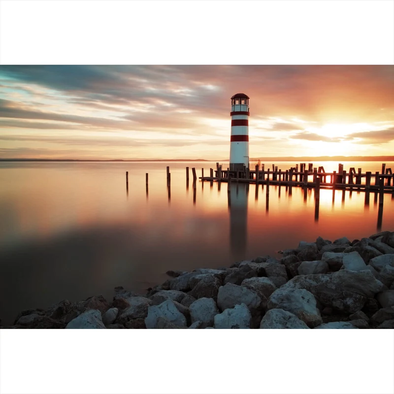 Spannrahmenbild Leuchtturm am Meer in der Abenddämmerung Querformat